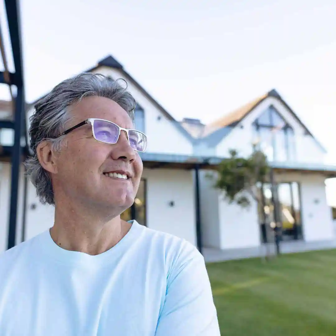 Home owner smiling in front of home