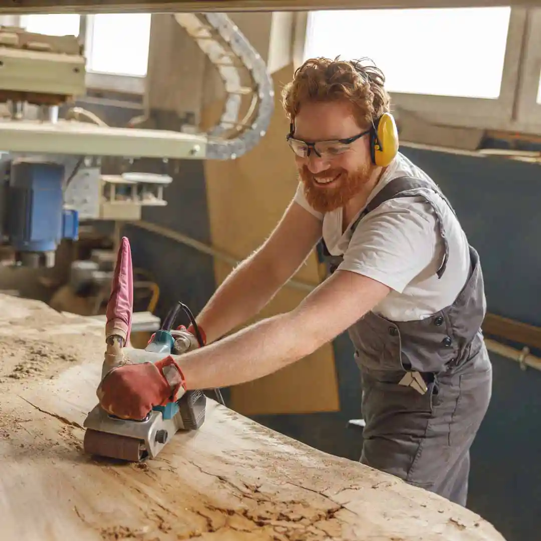 A man sanding a wood surface